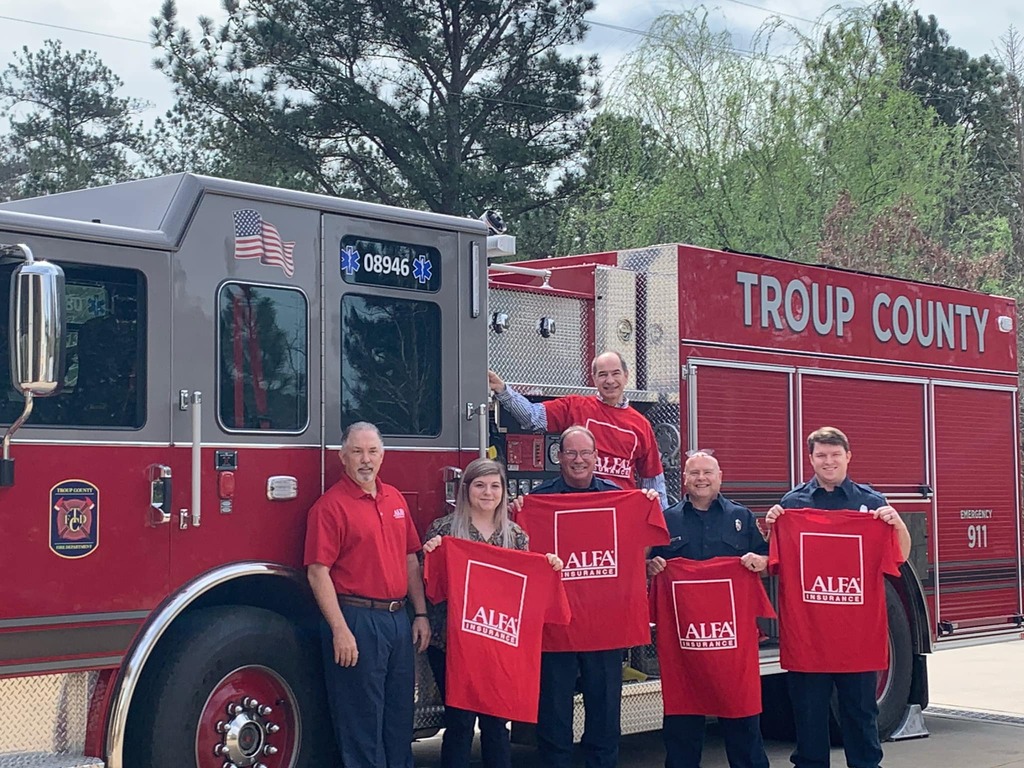 ALFA employees in front of fire truck